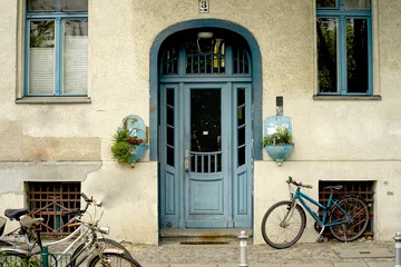 Velvet curtains Old door House facade with blue door and windows. Architecture of Berlin. Street in Berlin