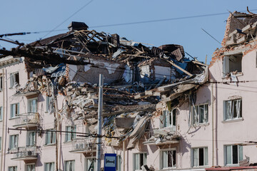 Damaged ruined house in ukrainian city Chernihiv near Kyiv on north of Ukraine. Ruins of hotel during War of Russia against Ukraine in 2022. Ruined roof, walls, windows of buildings. Aircraft attack - obrazy, fototapety, plakaty