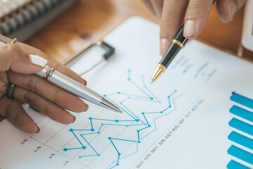 Two Asian business women are meeting to summarize the company's operating, financial, profit and loss results. Management of startup companies. Profitable management concept and growing management.