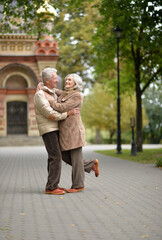 Obraz premium Happy senior woman and man in park