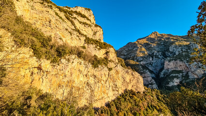 First sun beams during sunrise on summits of Monte San Michele, Molare, Canino, Caldare, Lattari Mountains, Apennines, Amalfi Coast, Italy, Europe. Hiking trail Path of Gods between Positano Praiano