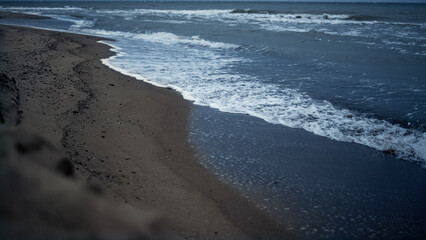 Beach waves crashing sand shoreline landscape. Blue ocean splashing coast nature