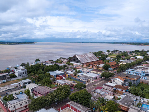 Beautiful drone aerial view of Amazonas river and Itacoatiara city skyline in the Amazon rainforest, Brazil. Concept of environment, ecology, cityscape, conservation, nature, urban, tourism.