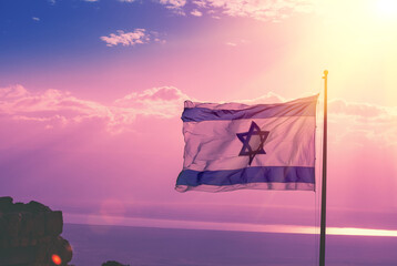 The flag of Israel flies at Masada against the morning sky