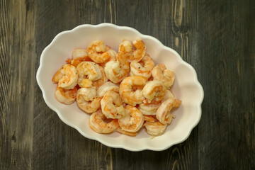 Top view of 16-20 size shrimp cooked with garlic and butter and fresh ground pepper.  