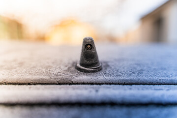 Rear window washer nozzle on a car covered with frost
