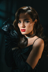 Fototapeta na wymiar Portrait of brunette woman in classic retro style. Beautiful girl with a hairstyle and makeup with jewelry in vintage retro noir look. Concept of actress from a Hollywood film