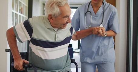 Animation of happy biracial female doctor taking care of caucasian senior man - Powered by Adobe