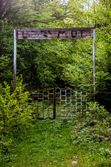 old rusty gate with a wooden sign in the Carpathian forest