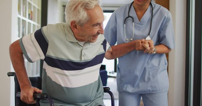 Animation of happy biracial female doctor taking care of caucasian senior man