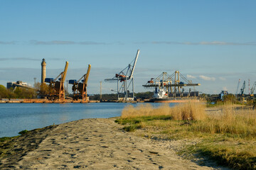 Fototapeta na wymiar industrial area on the coast. big cranes in the background. port