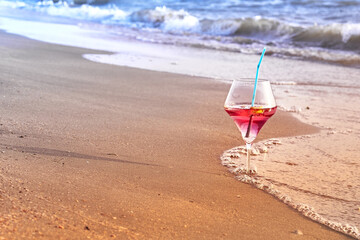 Wine glass with a cocktail by the sea.