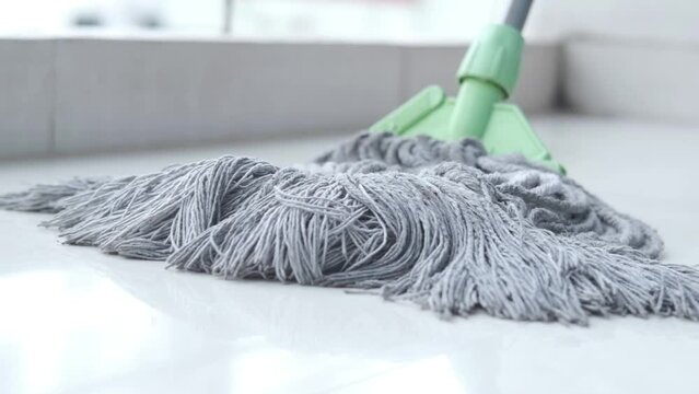cleaning tiles floor with mop 