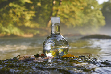 Flask with clear river water.