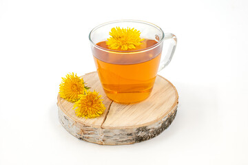 cup of dandelion tea on birch table and white background