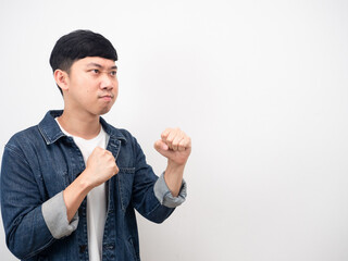 Asian man jean shirt angry face gesture boxing guard side view copy space