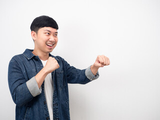 Asian man jean shirt gesture punch at copy space