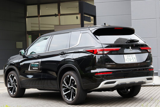 TOKYO, JAPAN - May 8, 2022: A Mitsubishi Outlander hydrid SUV for test driving outside a Mitsubishi showroom in Tokyo's Koto Ward.