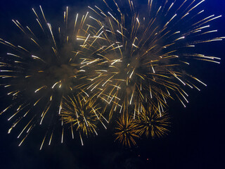 Fireworks in the night sky. Photo of fireworks in the sky. Abstract texture of the fireworks. Texture of bright lights, Multicolored flashes of lights.