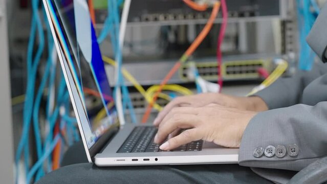 Male administrator it engineer conducts maintenance work in secure server room of cyberspace