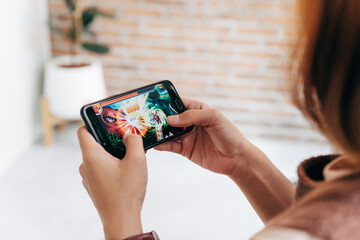 Young woman playing online game on smart phone. e-Sport Games compilation and Internet Championship.