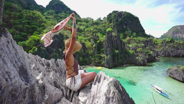 Woman Holding Shawl In Breeze On Limestone Rocks