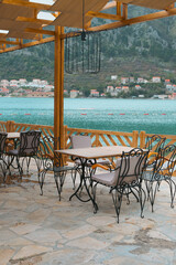 beautiful restaurant terrace made of eco materials on the beach with scenic seascape view, Kotor, Montenegro. leisure and relax concept, travel wallpaper