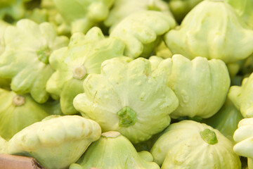 Above view of green pattypan summer squash piled for sale at Farmer's Market.