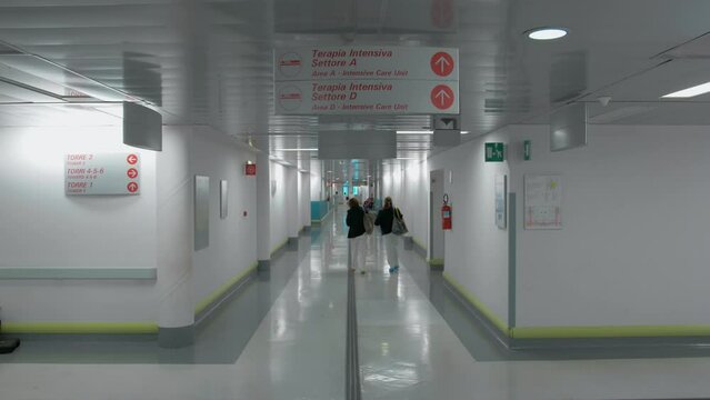 Hospital interior, two women at the end of the shift walking down the corridor