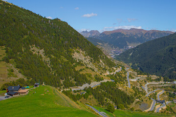 View of a curvy road in the mountain and a beautiful landscape during a sunny spring day in Andorra - obrazy, fototapety, plakaty