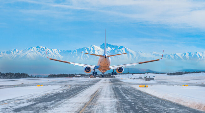 White passenger airplane landing on snowy airport - Oslo, Norway © muratart