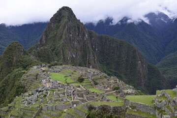 Ruins of the ancient Inca city machu picchu in fog, Peru