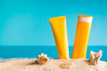 Fototapeta na wymiar Sunscreen lotion on sandy beach