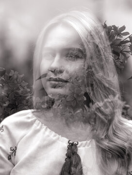 Portrait of young woman among blooming sakura with multi exposure artistic effect.