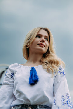 Portrait of young Ukrainian woman in national embroidered shirt.