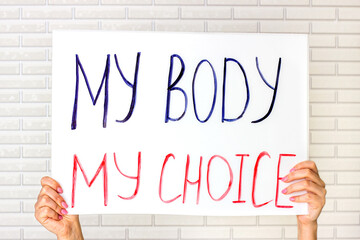 Woman holding a placard with My Body My Choice text. Reproductive women and pro-abortion rights...