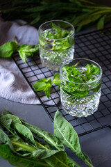 mint cocktail on iron grate on gray background
