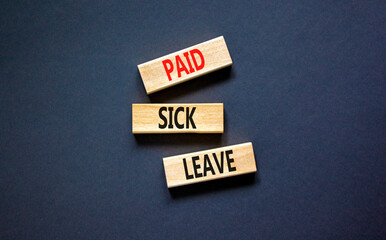 Paid sick leave symbol. Concept words Paid sick leave on wooden blocks. Beautiful black table black background. Business medical and paid sick leave concept. Copy space.