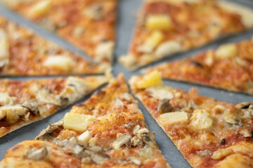 Cut into slices delicious fresh pizza. Top view . Pizza on the table.