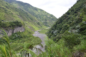 Fototapeta na wymiar River near by Cascada Manto de la Novia, waterfall in Banos de Agua Santa, Banos