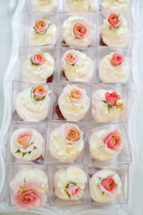 Table with loads of cakes and cupcakes in boxes