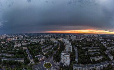 Epic sunset aerial urban panorama view in green city residential district. 23 serpnia, Pavlovo Pole, Kharkiv, Ukraine. Majestic evening skyscape, cloudscape and streets