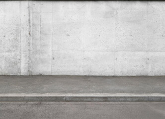 a fragment of a street city concrete wall of a building and an asphalt pavement. Building's facade. Template or layout
