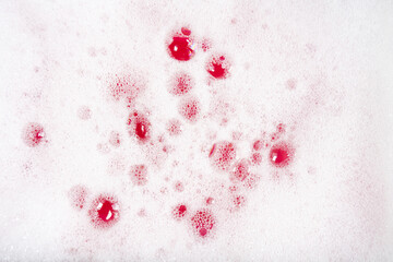 
Texture of white foam bubbles on a bright pink background. Banner for shampoo, soap, detergents. Shampoo bubbles.