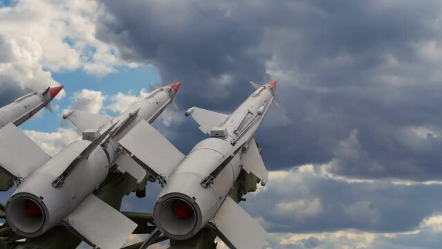 Anti aircraft air defense missiles on the launcher against the background of a cloudy sky with moving and swirling clouds. Time lapse video