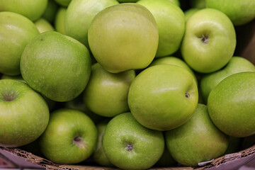 Green apples in the cardboard boxes on the supermarket shelf
