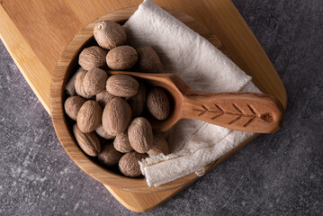 Nutmeg isolated on white background. Nutmeg powder. Nutmeg spice in a wooden spoon.