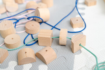 Sensory integration therapy - wooden geometric beads for stringing for preeschool (close up picture)