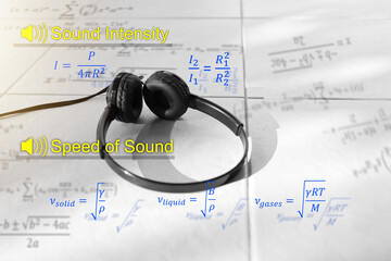 Black ear phone with sound intensity and speed of sound eqaution. physics equation concept.