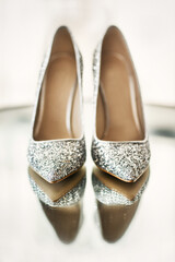 Wedding shoes on a mirror table